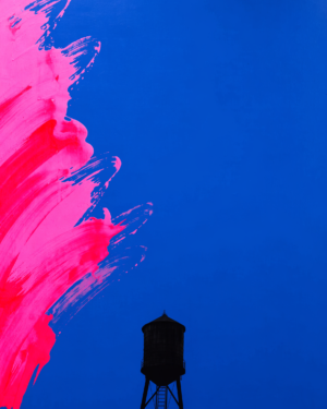 A flat cobalt blue field with a loose magenta bloom entering from the left edge and a simplified New York water tower in silhouette.