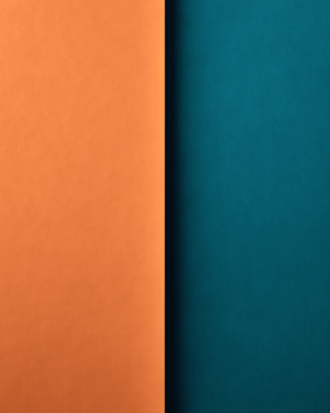 A tall composition split down the middle by a single vertical edge, warm terracotta on one side and cool teal on the other.