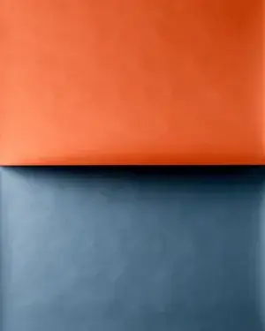 A tall abstract composition of two large flat colour planes, one warm and one cool, meeting along a single straight edge across the frame. A tall abstract composition of two large flat colour planes, one warm and one cool, meeting along a single straight edge across the frame.