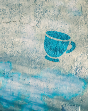 A sun-bleached mint plaster wall with cracks and a painted-over patch, with a small tilted turquoise stencilled coffee cup near one edge.